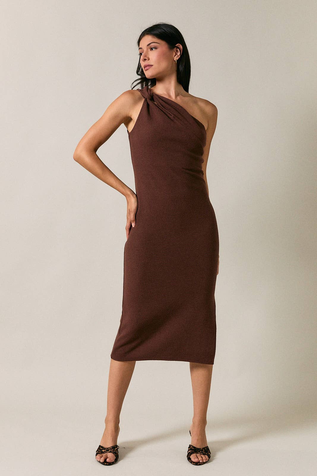 Model wearing Apricot Lane Duluth brown one-shoulder midi dress with cutout detail and textured fabric