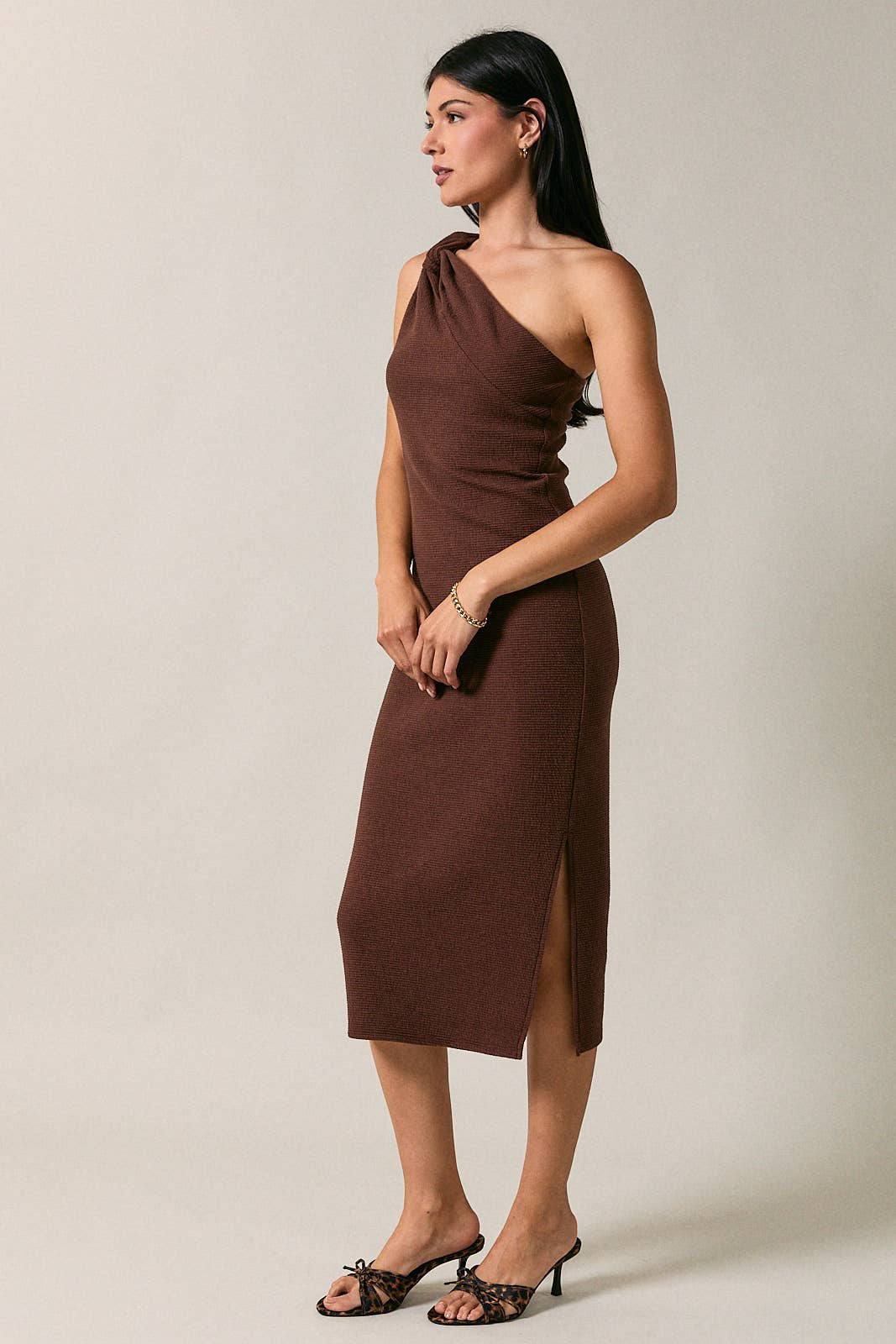 Apricot Lane Duluth Gabrielle one-shoulder brown midi dress with side slit and cutout detail on a model