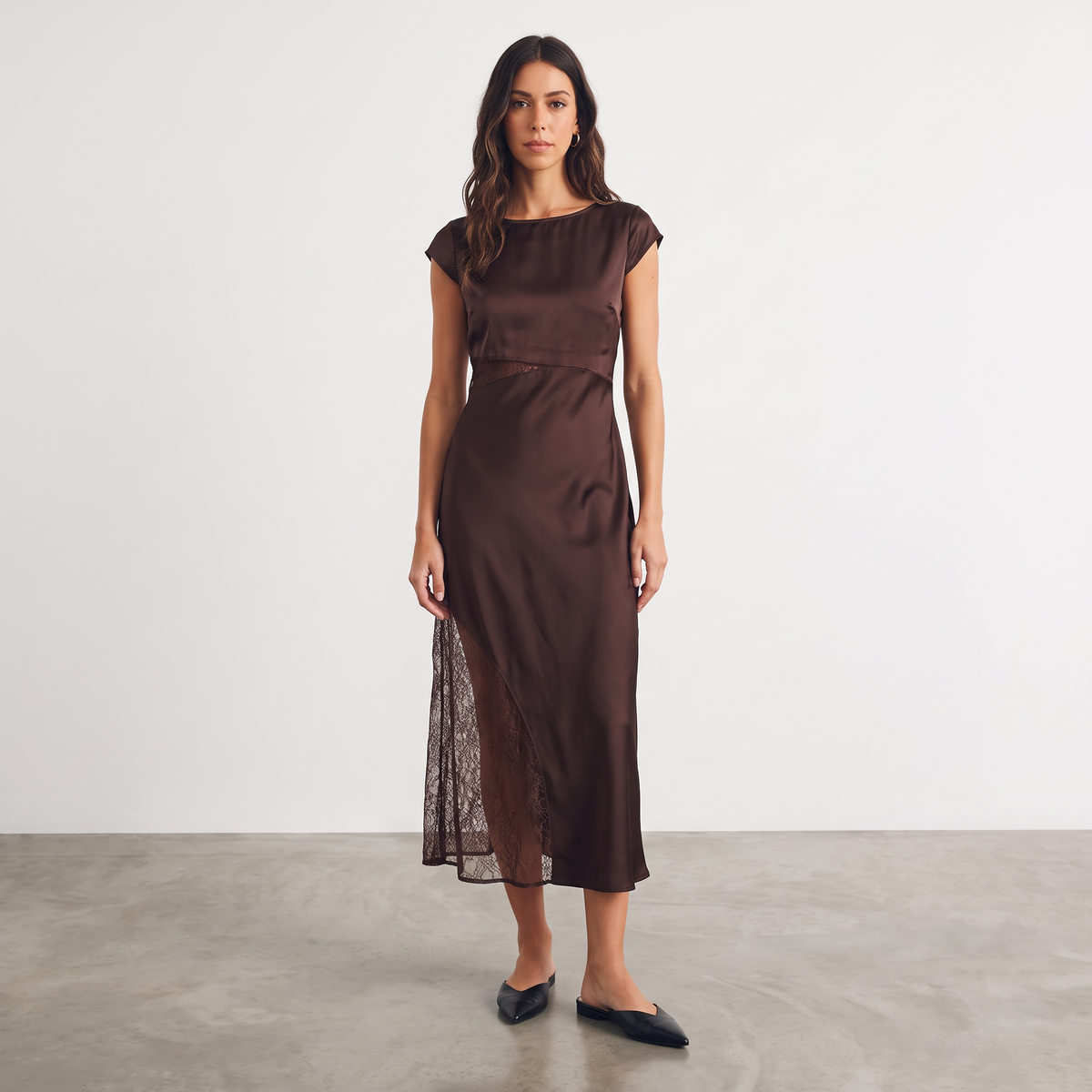 Model wearing Apricot Lane Duluth brown satin midi dress with cap sleeves and sheer lace waist and skirt inserts