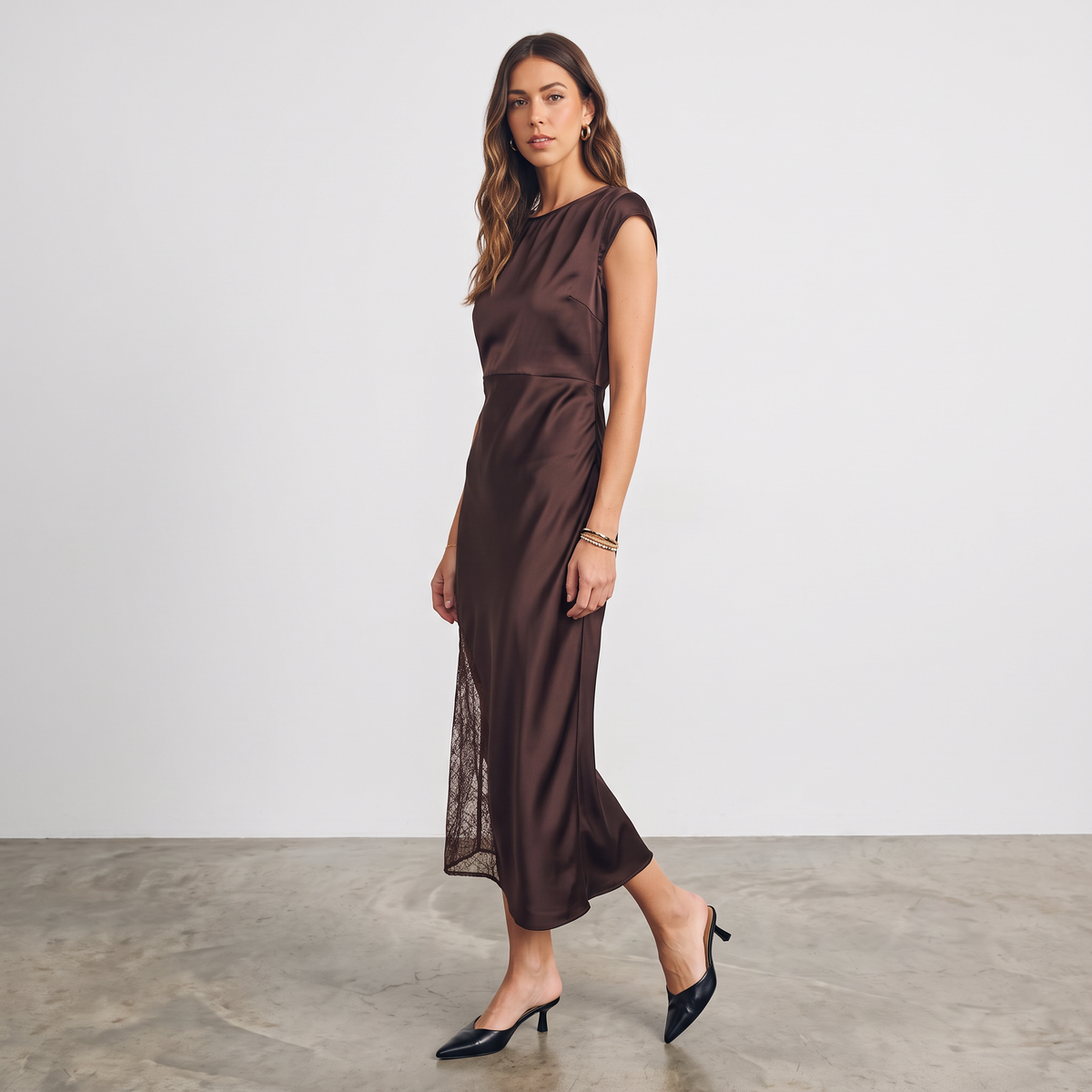 Model wearing Apricot Lane Duluth brown satin midi dress with cap sleeves and delicate lace waist and hem inserts.