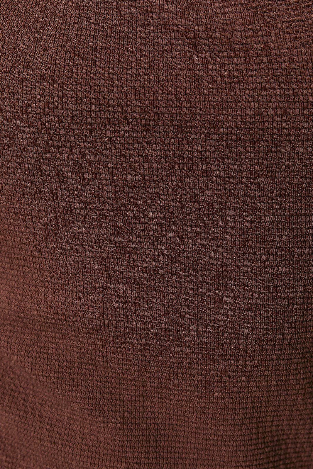 Close-up of the dark brown textured fabric of The Gabrielle One-Shoulder Cutout Midi Dress from Apricot Lane Duluth.