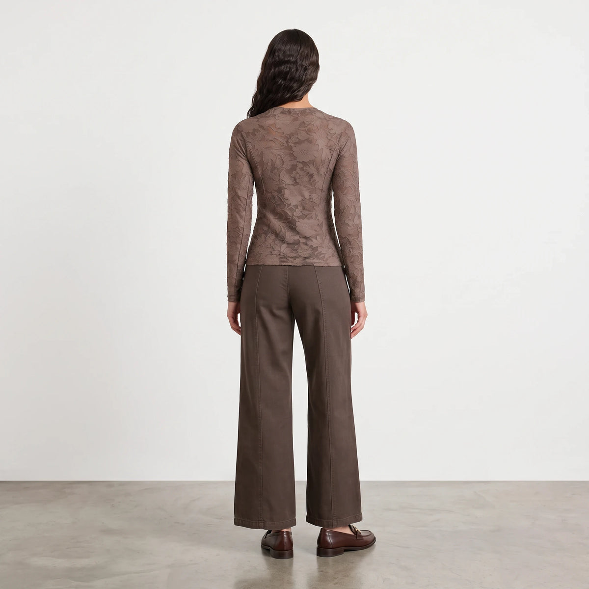 Model wearing Apricot Lane Duluth Camilla Tencel wide leg pants in brown with a matching lace long sleeve top