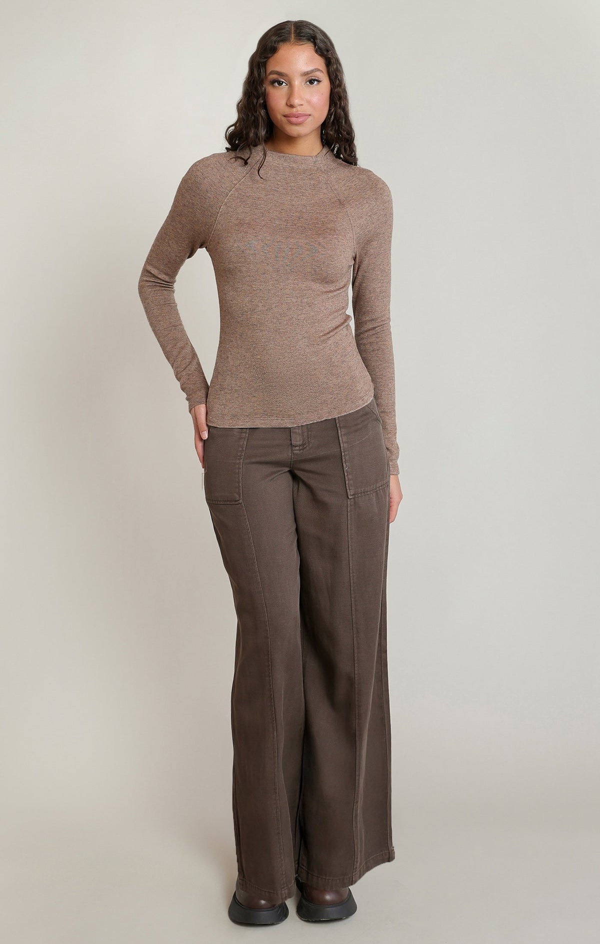 Model wearing Apricot Lane Duluth Camilla Tencel wide-leg pants in dark brown twill with a matching long-sleeve top.