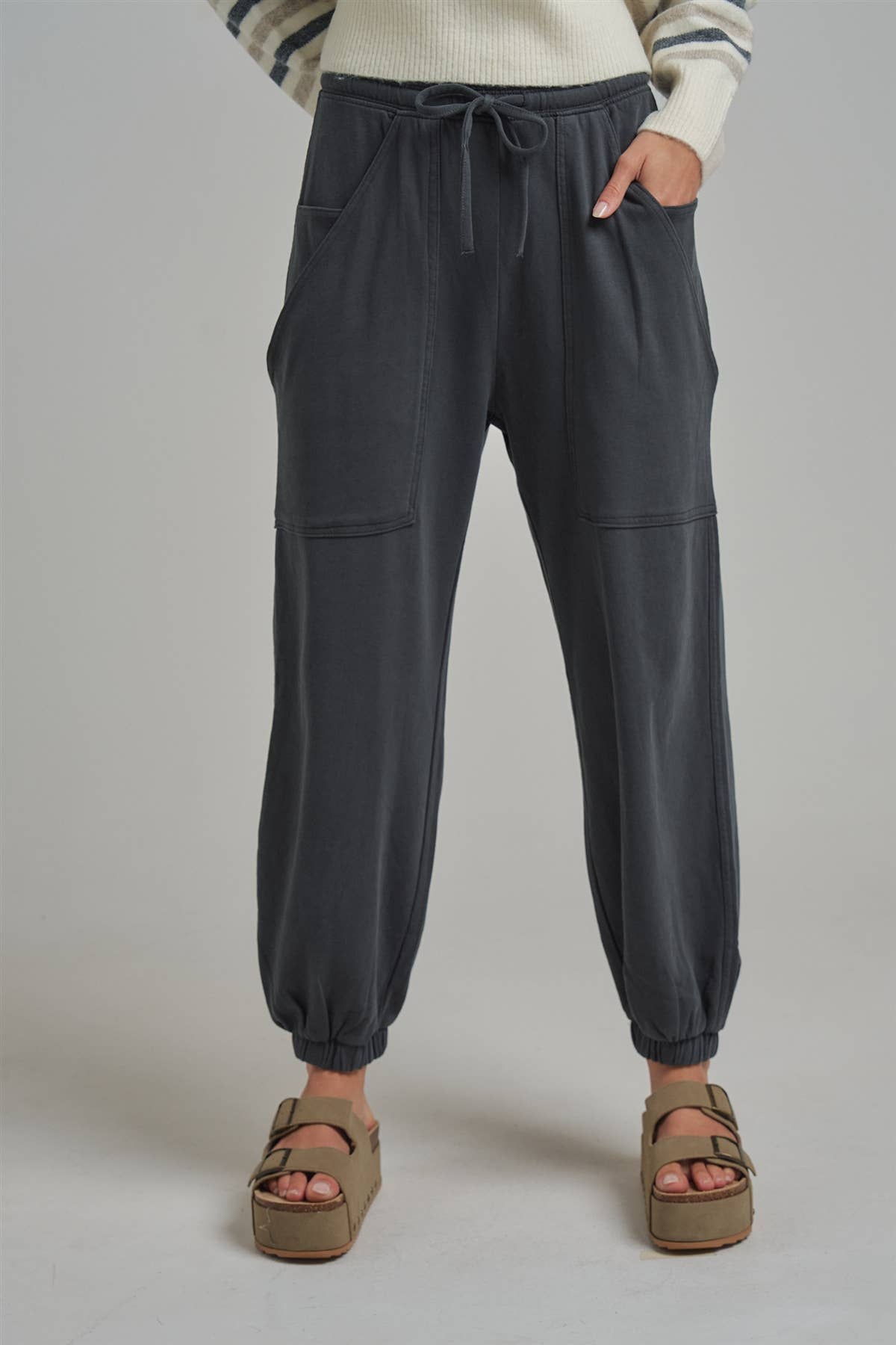 Apricot Lane Duluth Dakota cargo joggers in charcoal grey with an elastic drawstring waist and oversized pockets.