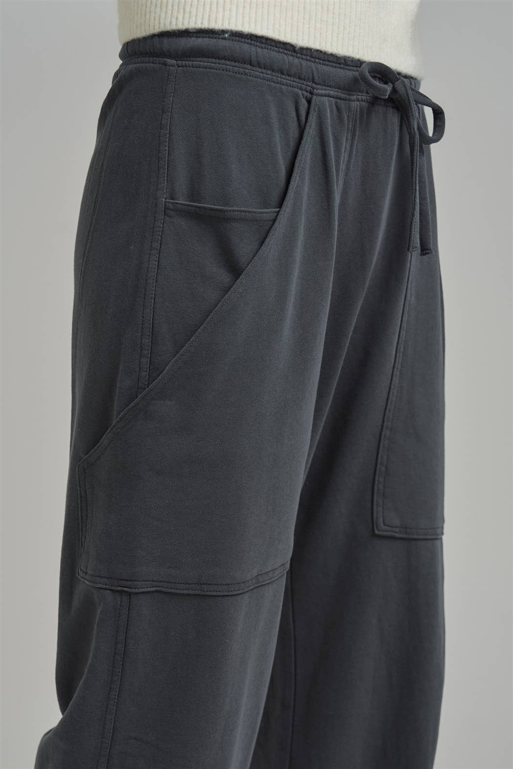 Apricot Lane Duluth Dakota cargo joggers in charcoal grey with oversized pockets and an elastic drawstring waist.
