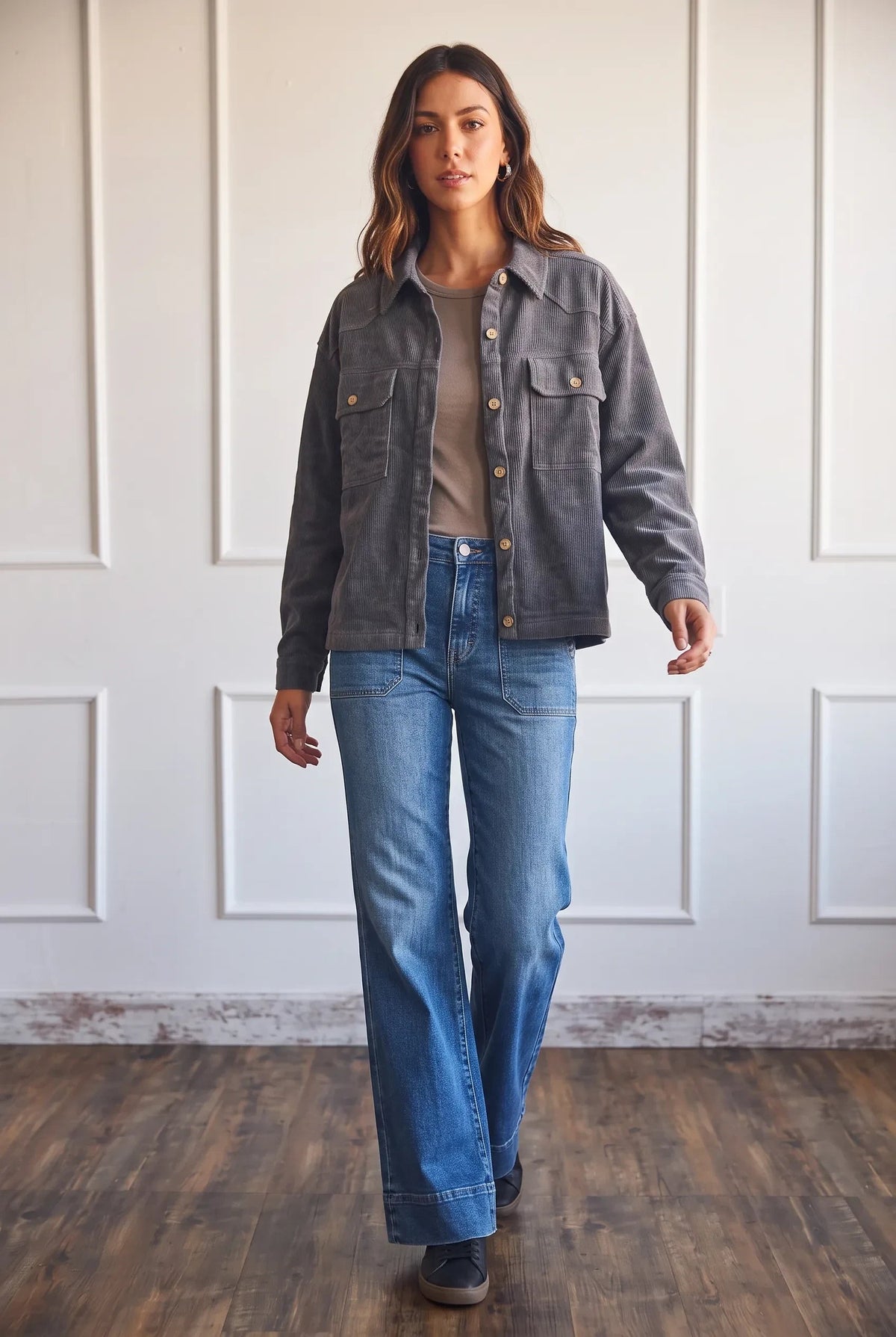 Model wearing an Apricot Lane Duluth charcoal grey oversized corduroy shacket with blue jeans and a neutral top.