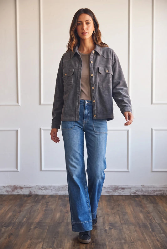 Model wearing an Apricot Lane Duluth charcoal grey oversized corduroy shacket with blue jeans and a neutral top.
