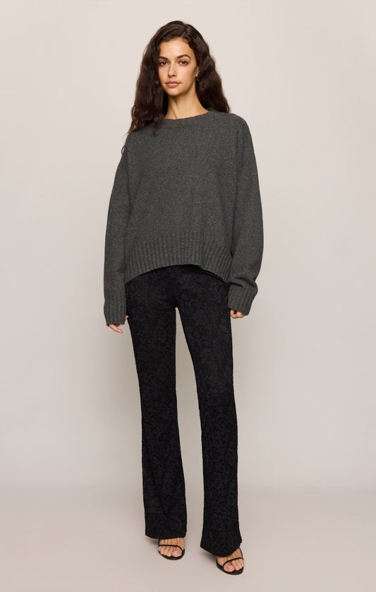 Model wearing an Apricot Lane Duluth charcoal grey crew neck pullover sweater with long sleeves and a relaxed fit