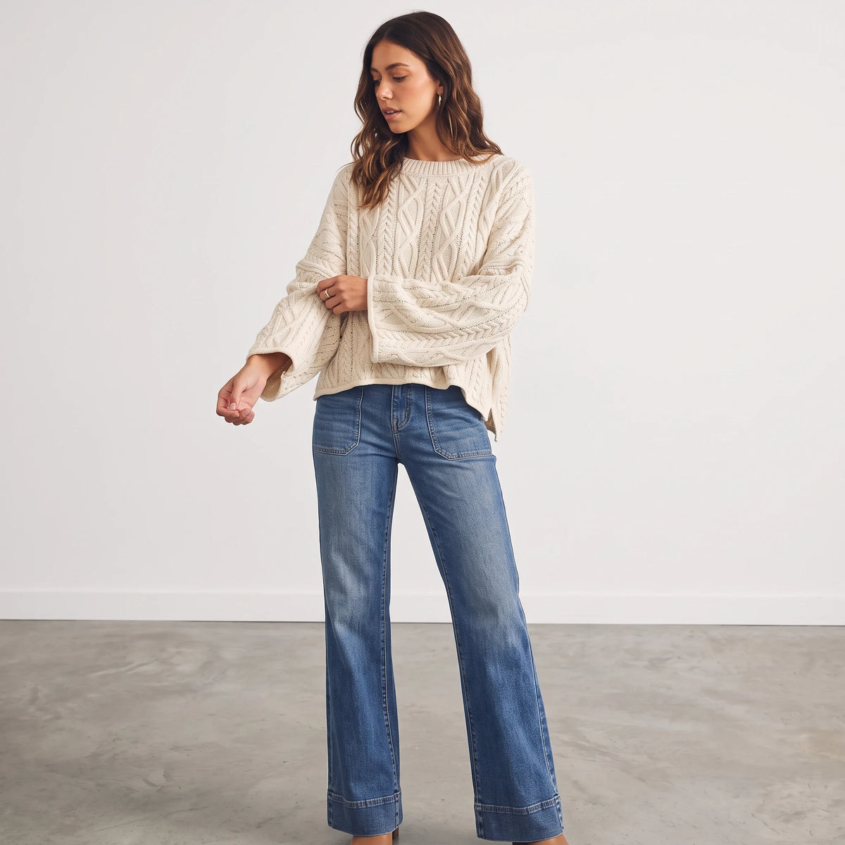 Apricot Lane Duluth oversized cream cable knit sweater with long sleeves worn with blue flare jeans