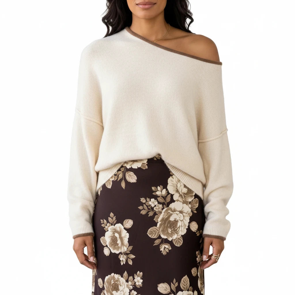 Apricot Lane Duluth Autumn Glow Sweater in cream with brown trim, featuring a relaxed off-the-shoulder neckline.