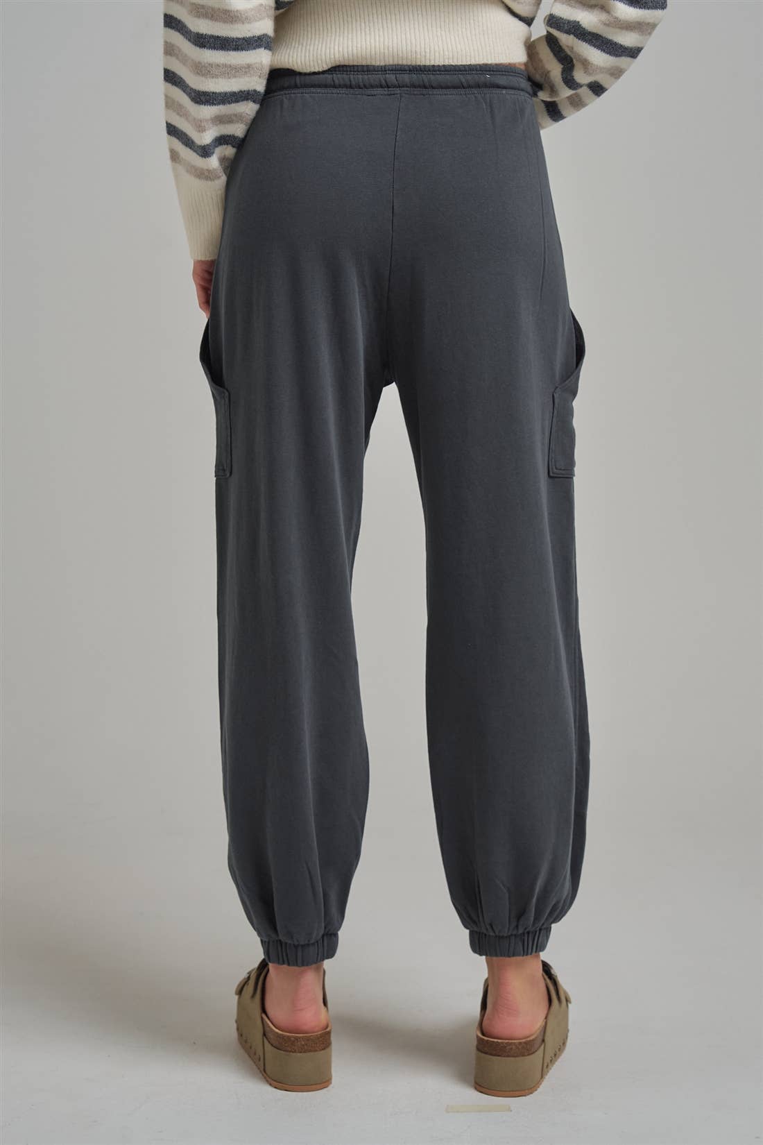 Back view of Apricot Lane Duluth Dakota cargo joggers in charcoal with elastic cuffs and oversized side pockets