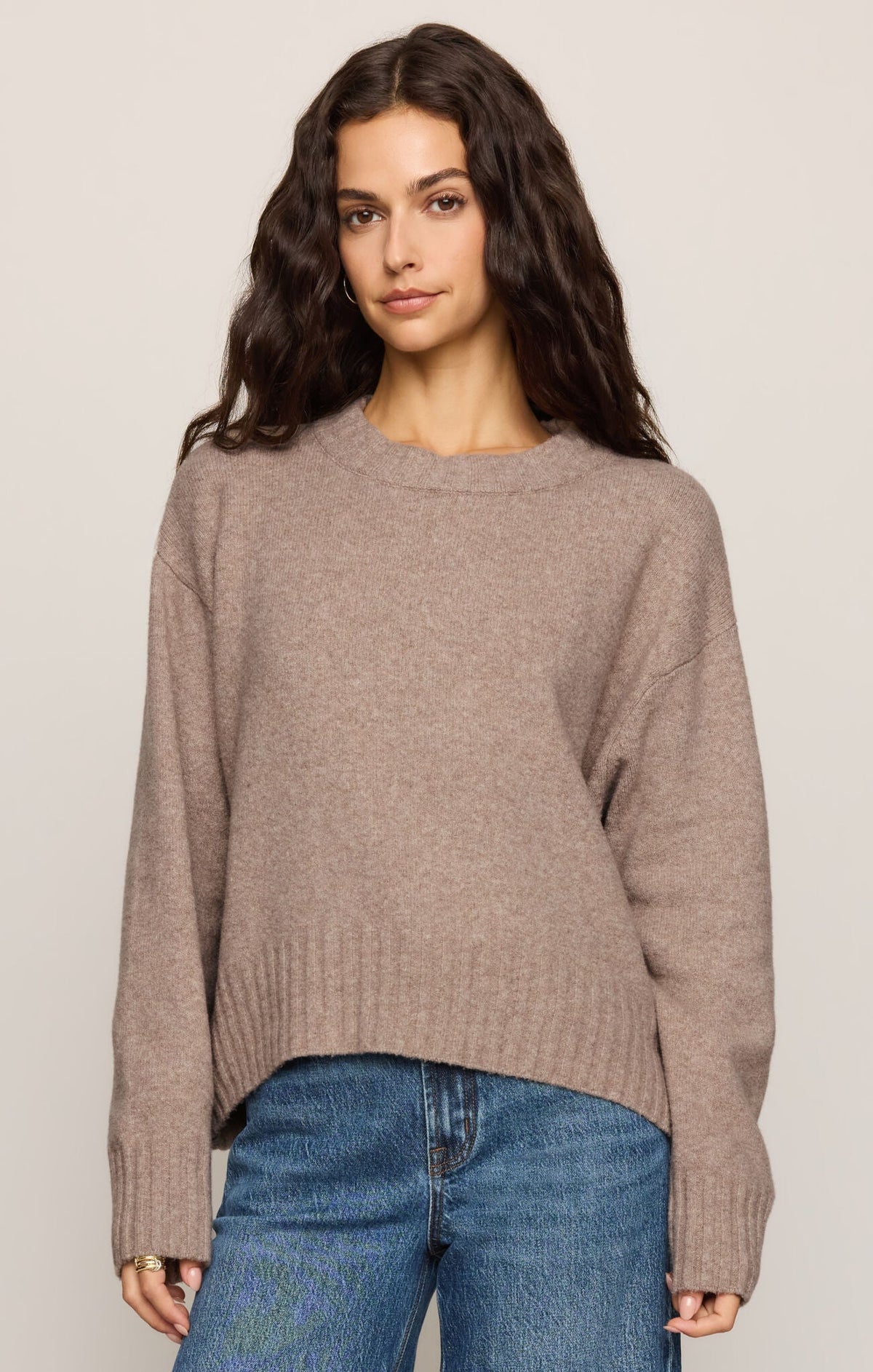 Model wearing an Apricot Lane Duluth Easton crew neck pullover sweater in a soft taupe Cirrus Cozy Yarn blend