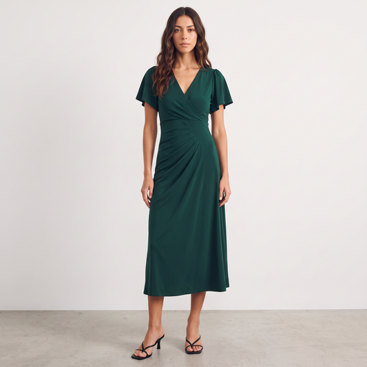 Apricot Lane Duluth Isabelle emerald green midi dress with surplice V-neck, flutter sleeves, and asymmetric pleating.