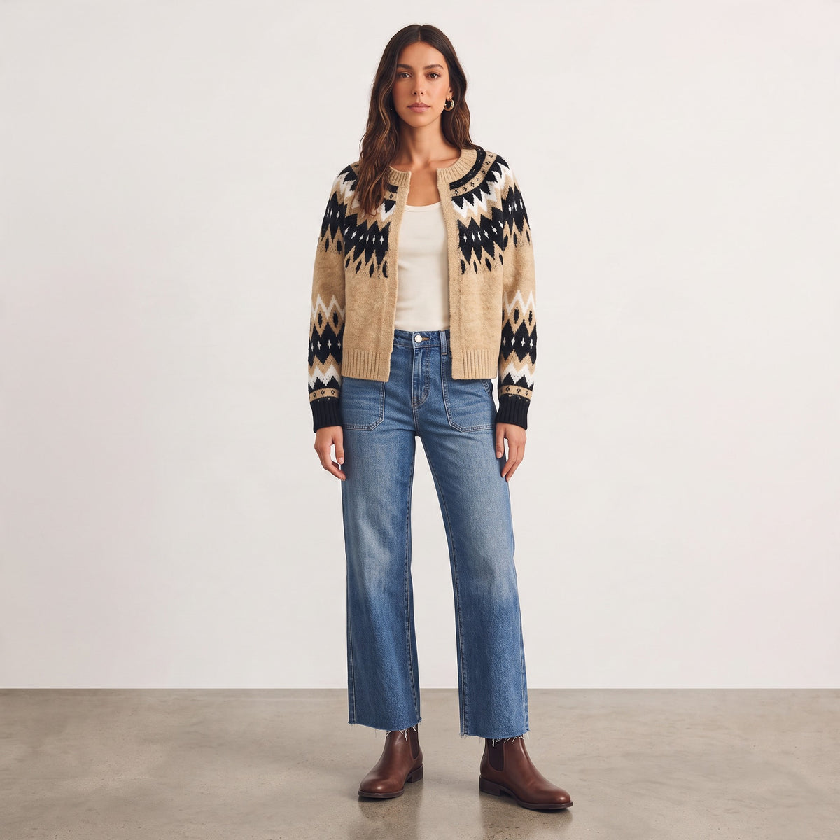 Model wearing an Apricot Lane Duluth taupe, black, and ivory Fair Isle knit cardigan with jeans and ankle boots.