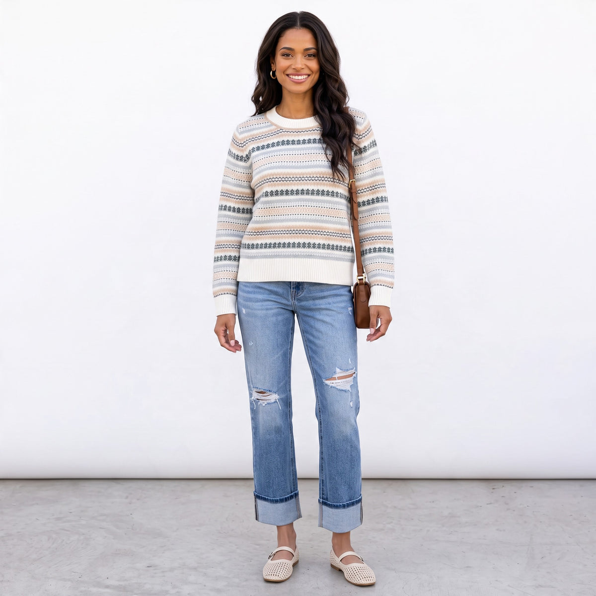 Apricot Lane Duluth Fair Isle sweater in ivory with evergreen, blue, and taupe stripes, worn with distressed jeans.