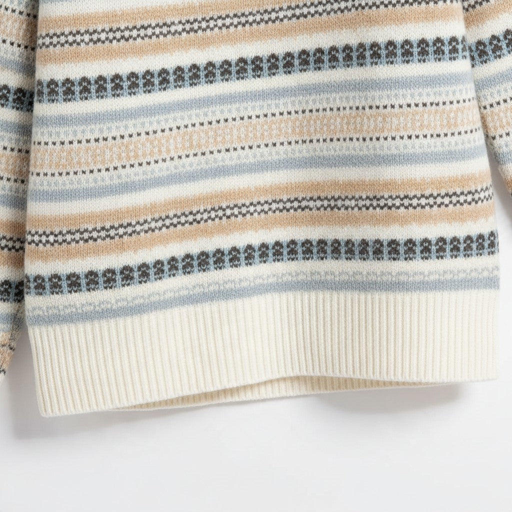 Apricot Lane Duluth Fair Isle sweater in ivory with evergreen, blue, and taupe stripes and ribbed hem detail.