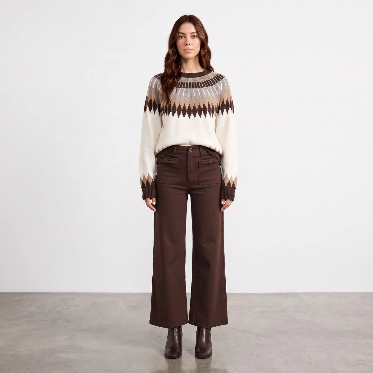 Model wearing Apricot Lane Duluth Brynn Fair Isle yoke sweater with geometric patterns and brown wide-leg trousers.