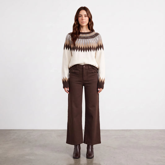 Model wearing Apricot Lane Duluth Brynn Fair Isle yoke sweater with geometric patterns and brown wide-leg trousers.