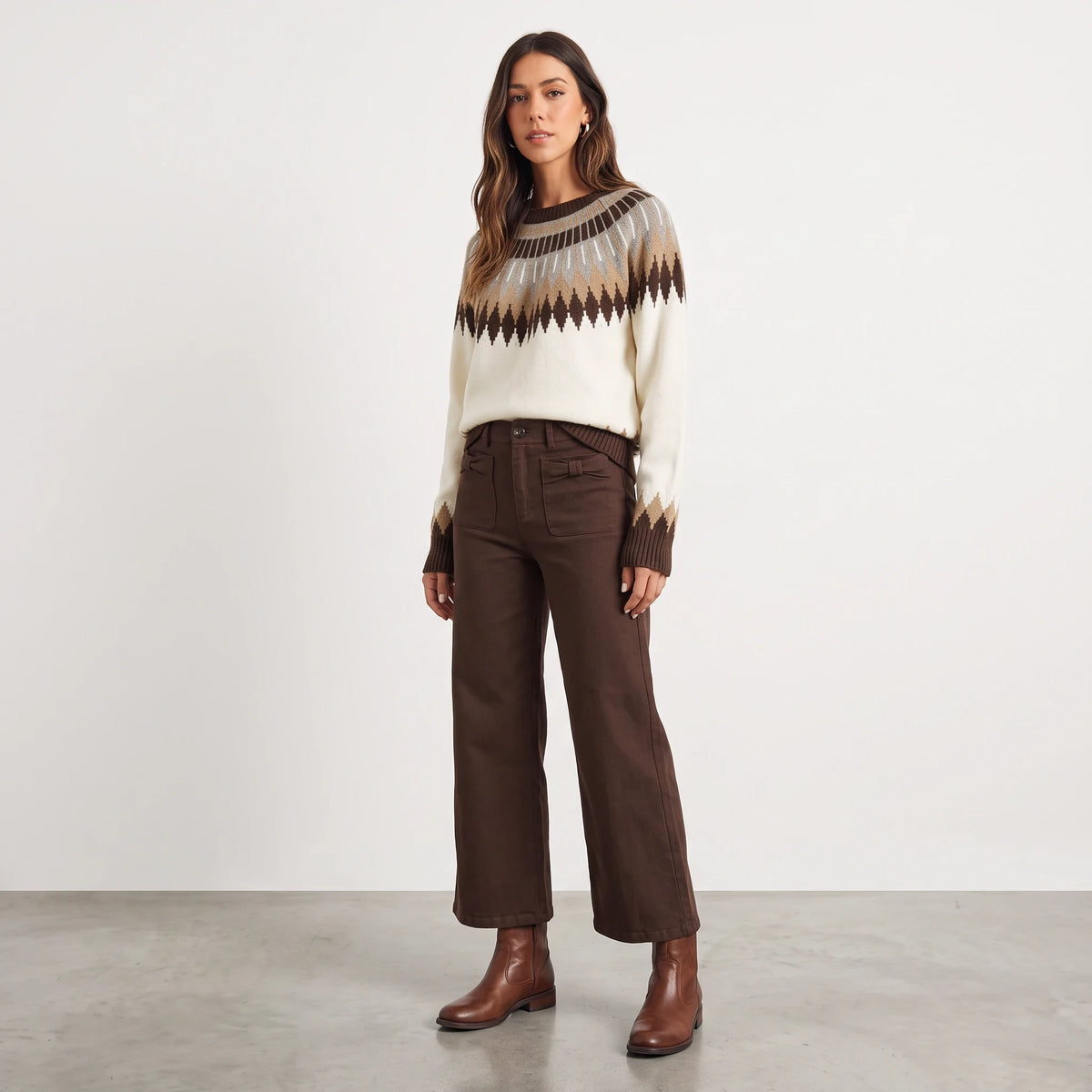 Model wearing Apricot Lane Duluth Brynn Fair Isle Yoke Sweater in cream and brown with geometric patterns and denim.