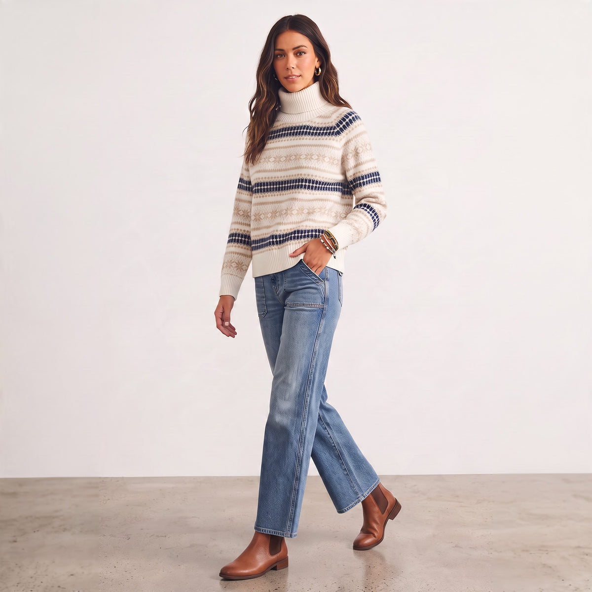 Apricot Lane Duluth ivory Fair Isle turtleneck sweater with navy and taupe geometric patterns worn with blue jeans.