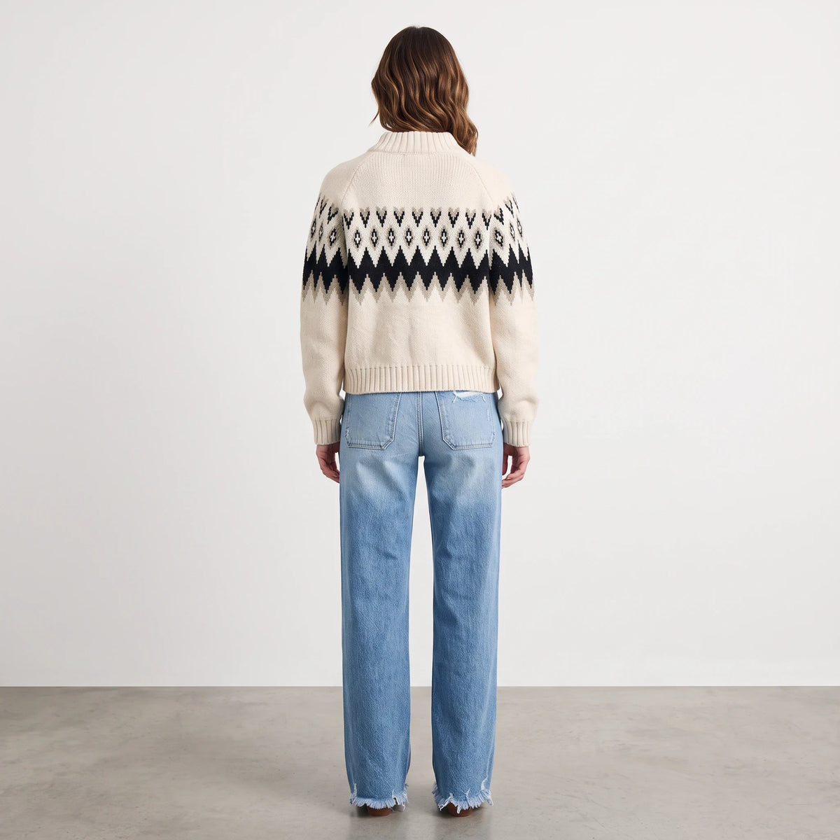 Apricot Lane Duluth Aspen Fair Isle zip cardigan in cream and black worn with blue jeans, back view