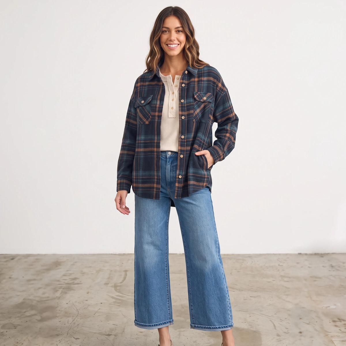 Model wearing Apricot Lane Duluth Fallon brushed flannel jacket in navy and brown plaid with jeans and a cream top