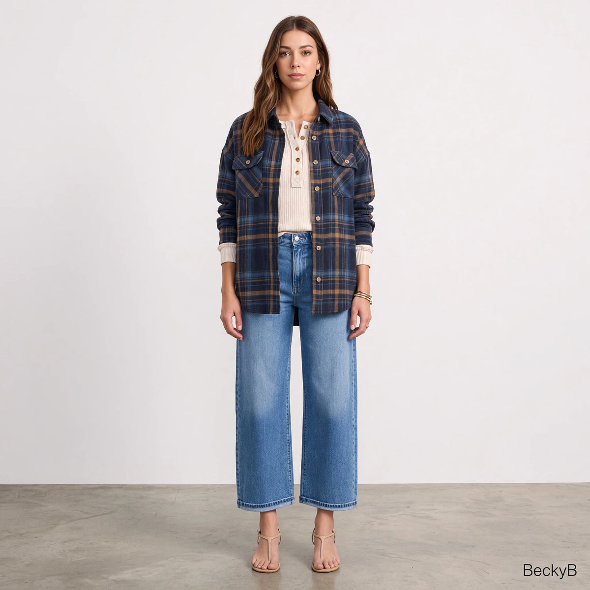 Model wearing Apricot Lane Duluth Fallon brushed flannel plaid jacket with chest pockets over a cream henley and jeans