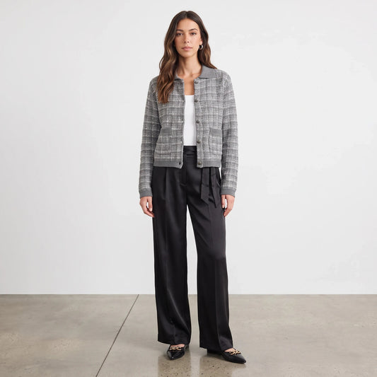 Model wearing Apricot Lane Duluth Cora tweed knit cardigan in grey with black trousers and pointed flats