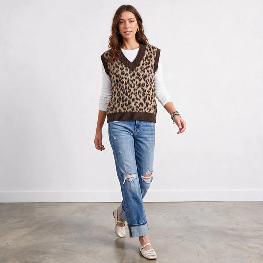 Model wearing Apricot Lane Duluth leopard print fuzzy sweater vest over a white long-sleeve top and distressed jeans