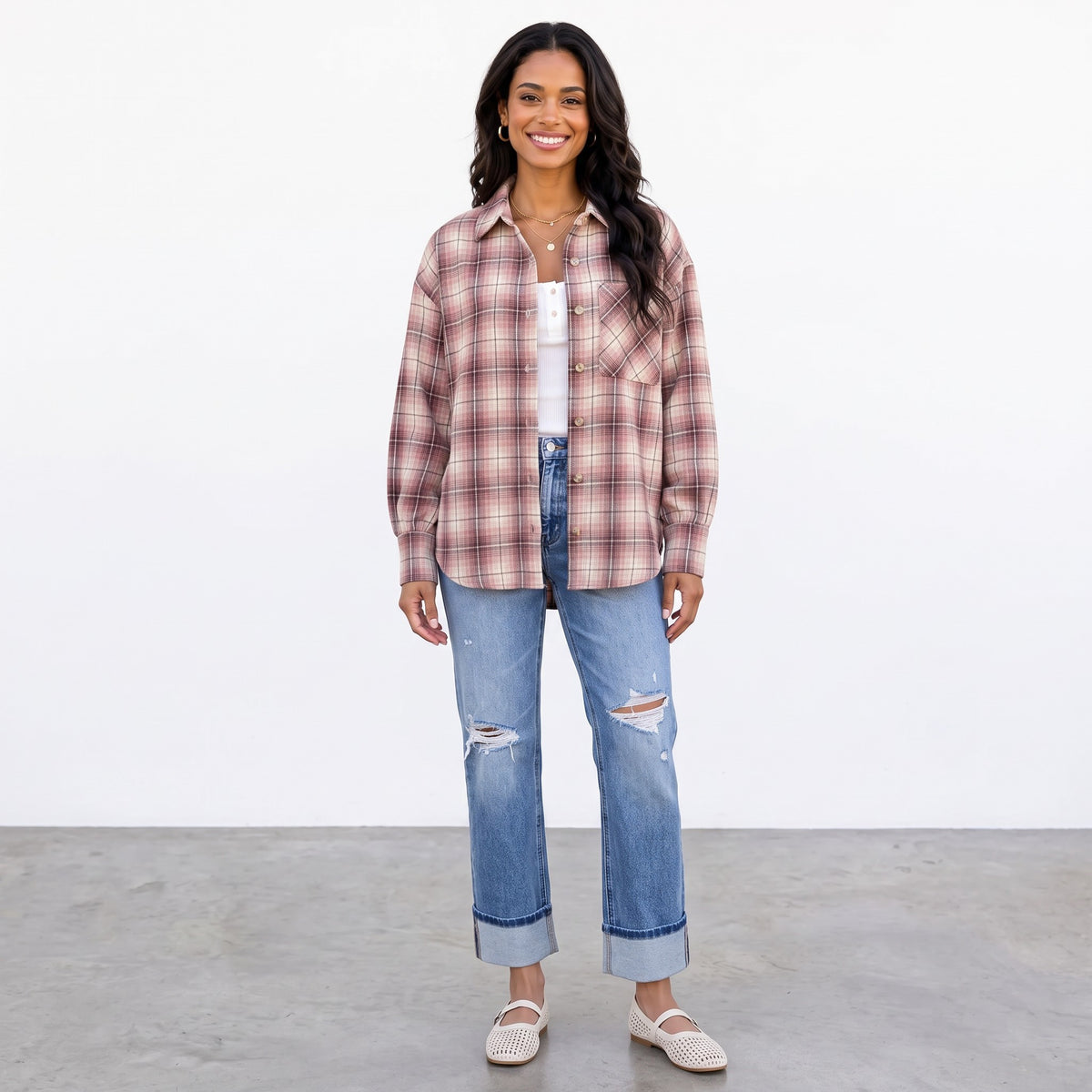 Apricot Lane Duluth Maren plaid button-down shirt worn open over a white top with distressed blue jeans