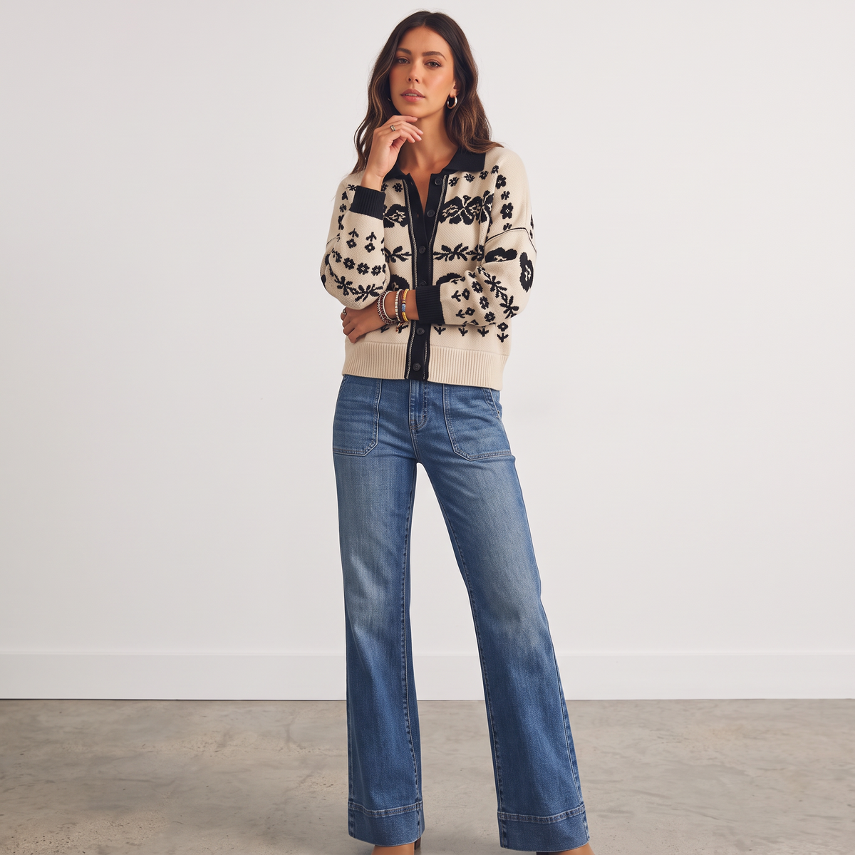 Apricot Lane Duluth Marlowe cardigan with black floral jacquard pattern on cream, worn with blue denim jeans