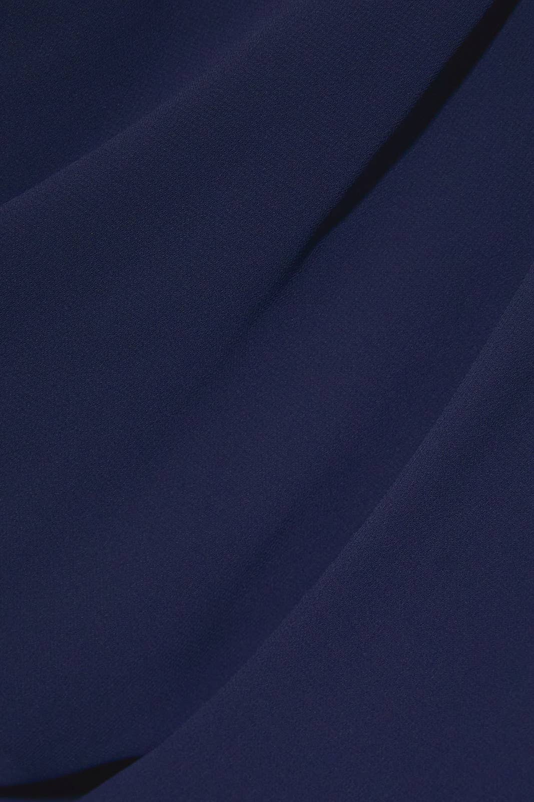 Close-up of the navy blue woven crepe fabric of the Apricot Lane Duluth Midnight Muse one-shoulder midi dress.