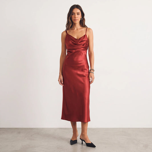 Model wearing Apricot Lane Duluth red satin midi dress with asymmetrical cowl neckline and cami straps