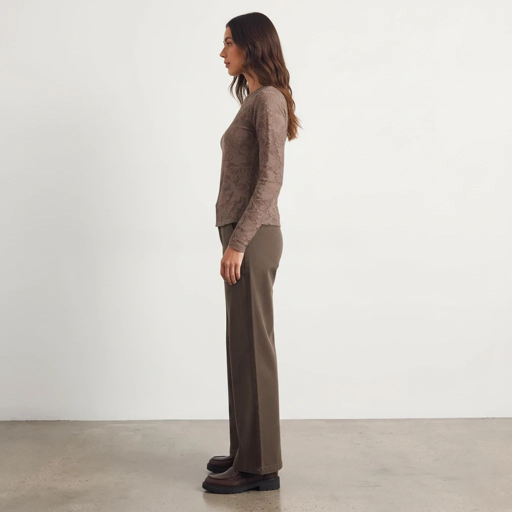 Model wearing Apricot Lane Duluth Roselyn floral long sleeve top in brown with matching trousers and loafers