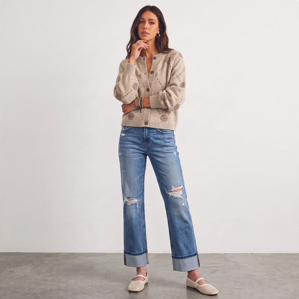 Model wearing Apricot Lane Duluth beige wool-blend cardigan with snowflake jacquard pattern, jeans, and flats.