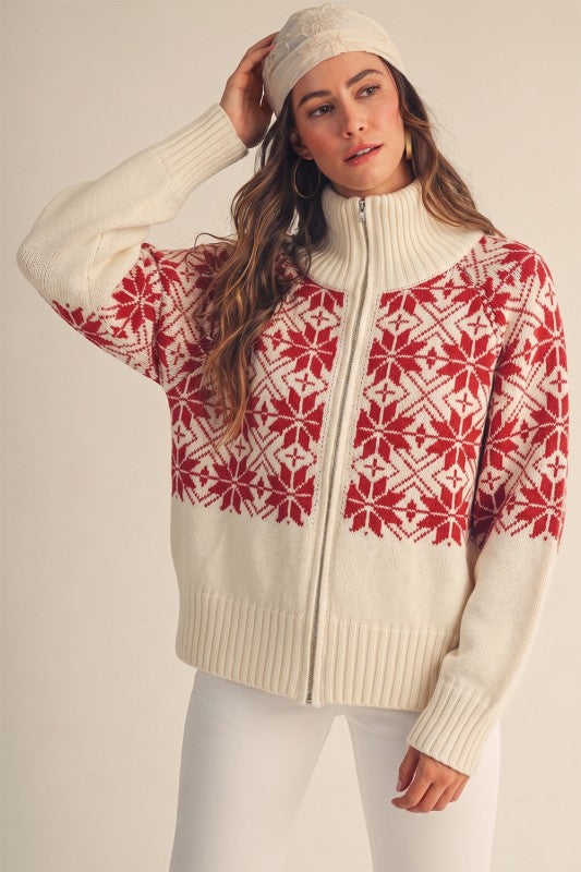 Model wearing an Apricot Lane Duluth cream and red Fair Isle snowflake zip cardigan with a matching knit beanie