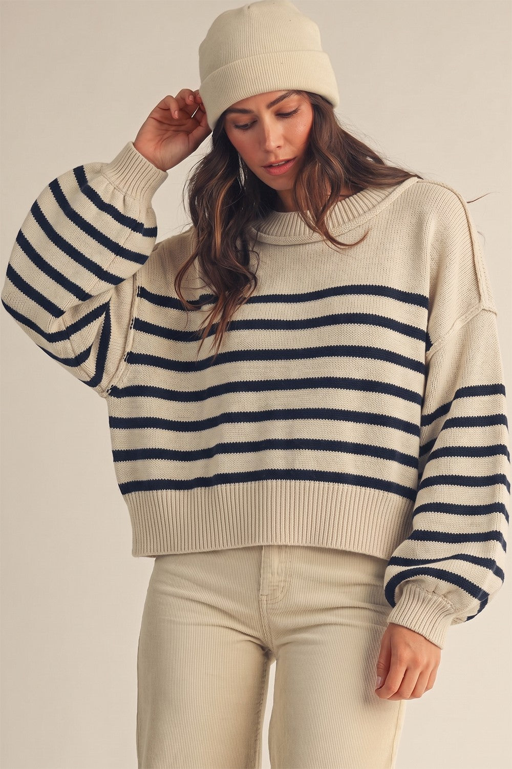 Model wearing an Apricot Lane Duluth striped cotton-blend sweater with a matching beanie for a cozy fall look.