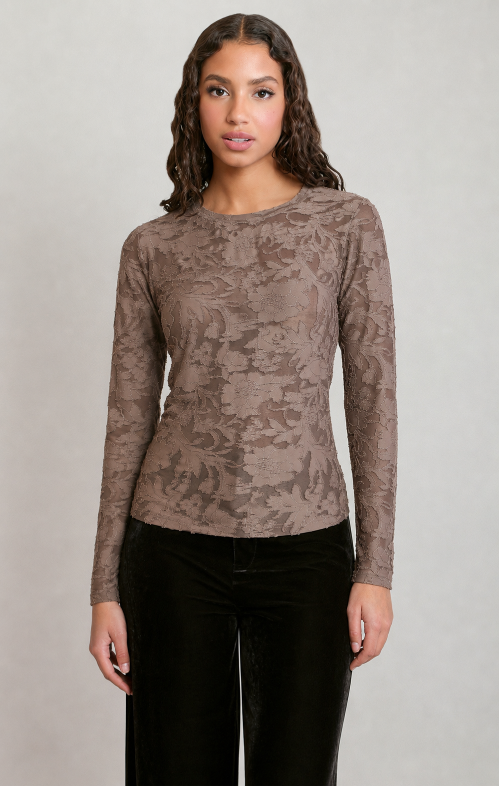 Model wearing an Apricot Lane Duluth brown floral long sleeve top with a crew neckline and soft stretch fabric.