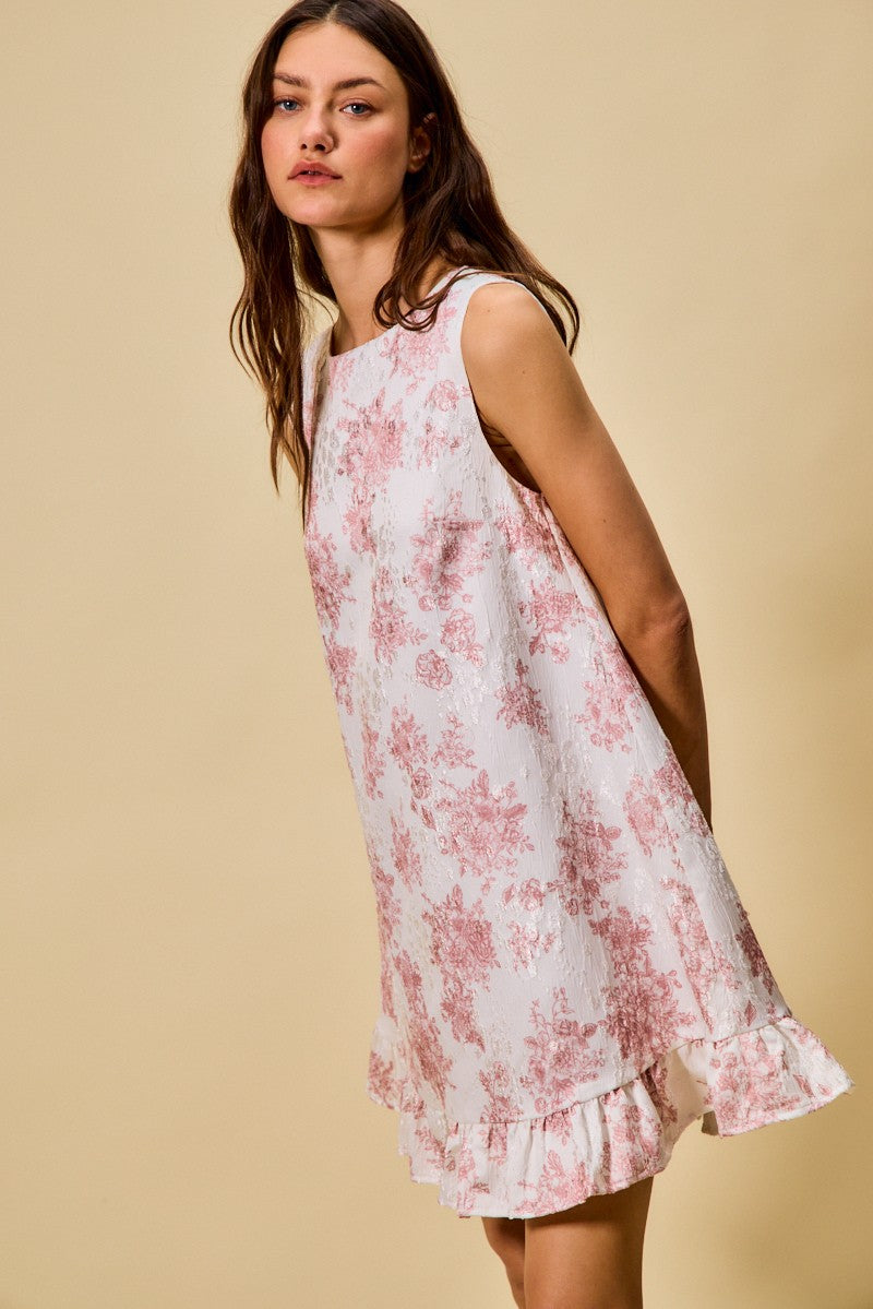 Woman wearing a floral dress against a beige background
