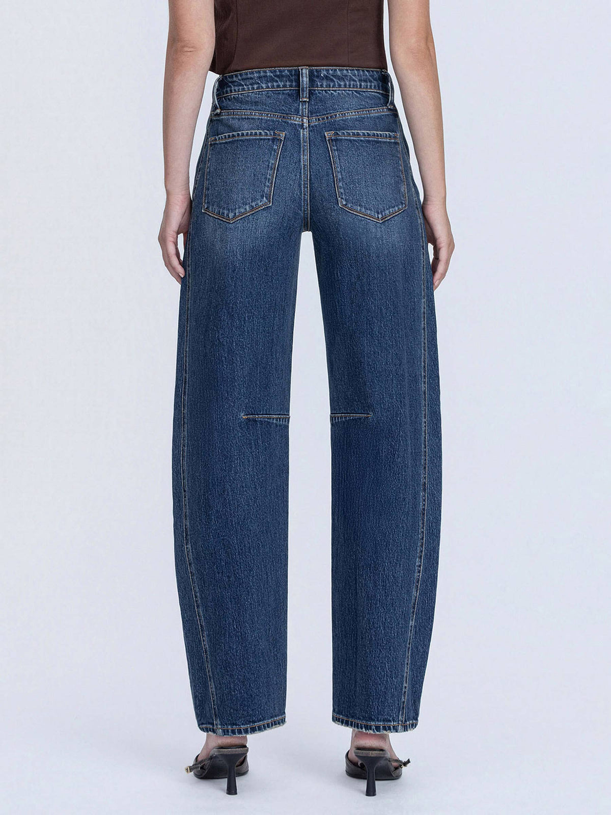 Person wearing blue jeans on a white background