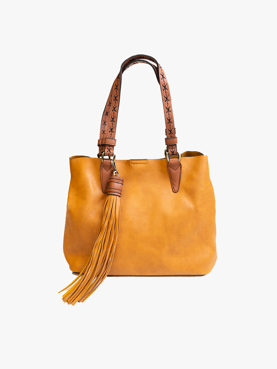 Brown leather handbag with a tassel on a white background