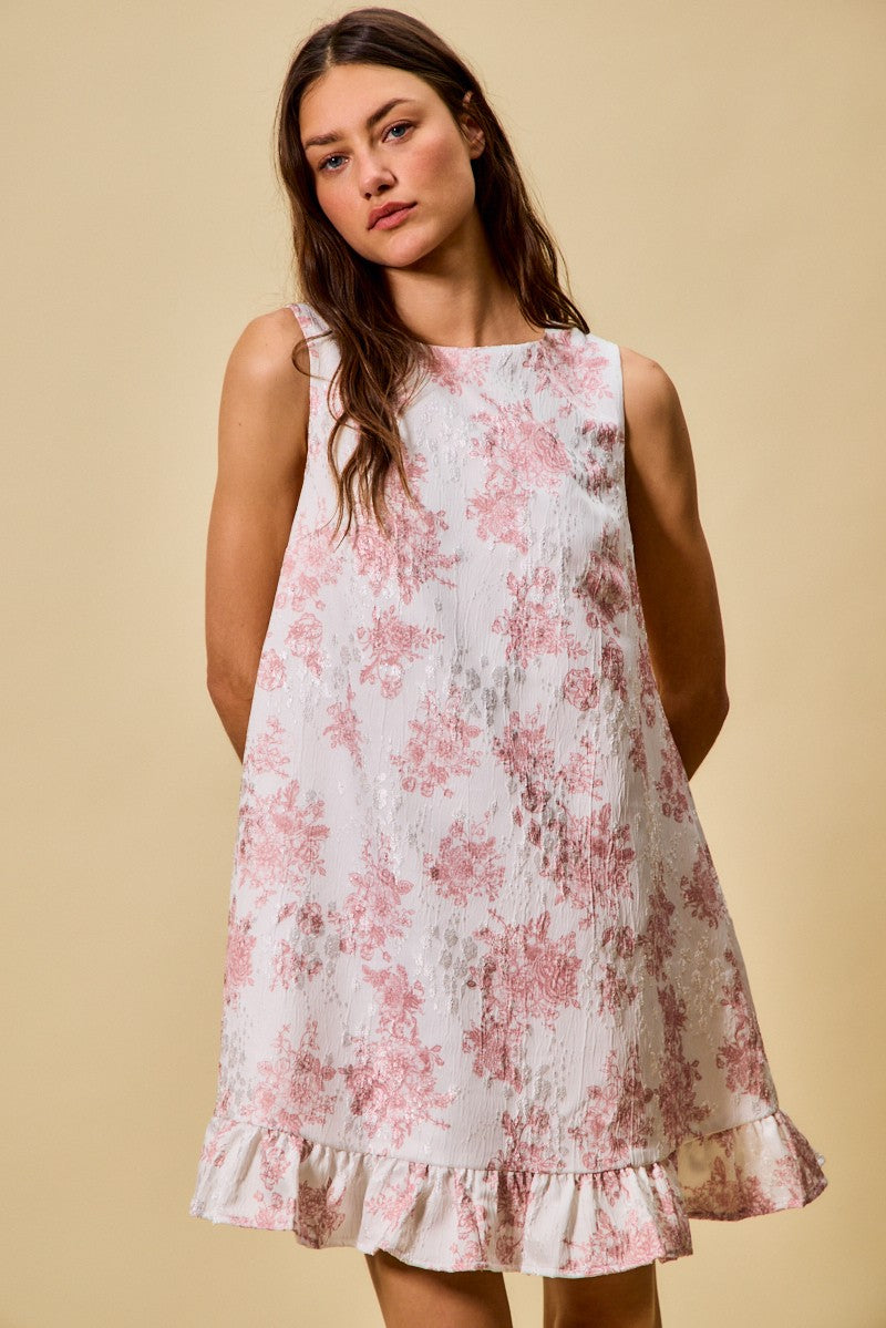 Woman wearing a floral dress against a beige background