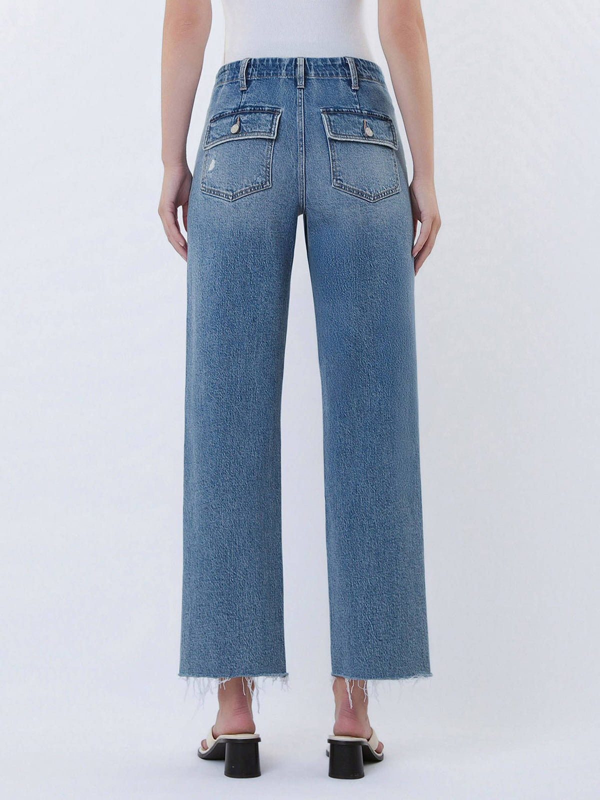 Person wearing blue jeans on a white background