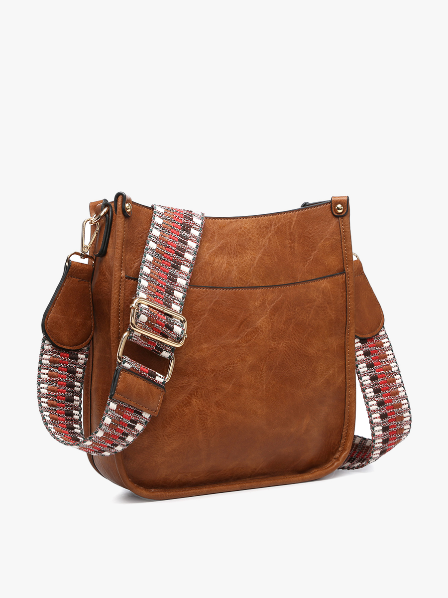 Brown leather handbag with decorative strap on a white background