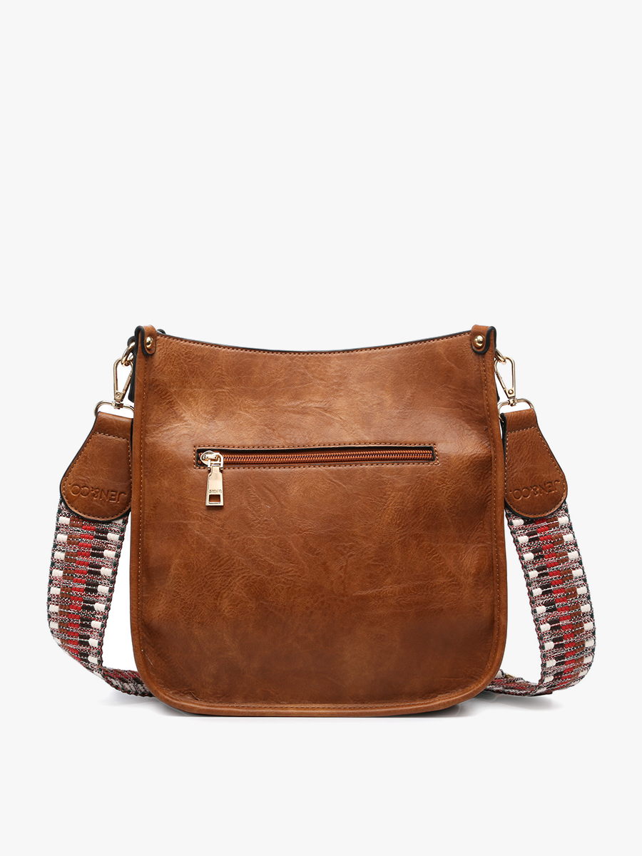 Brown leather handbag with decorative straps on a white background