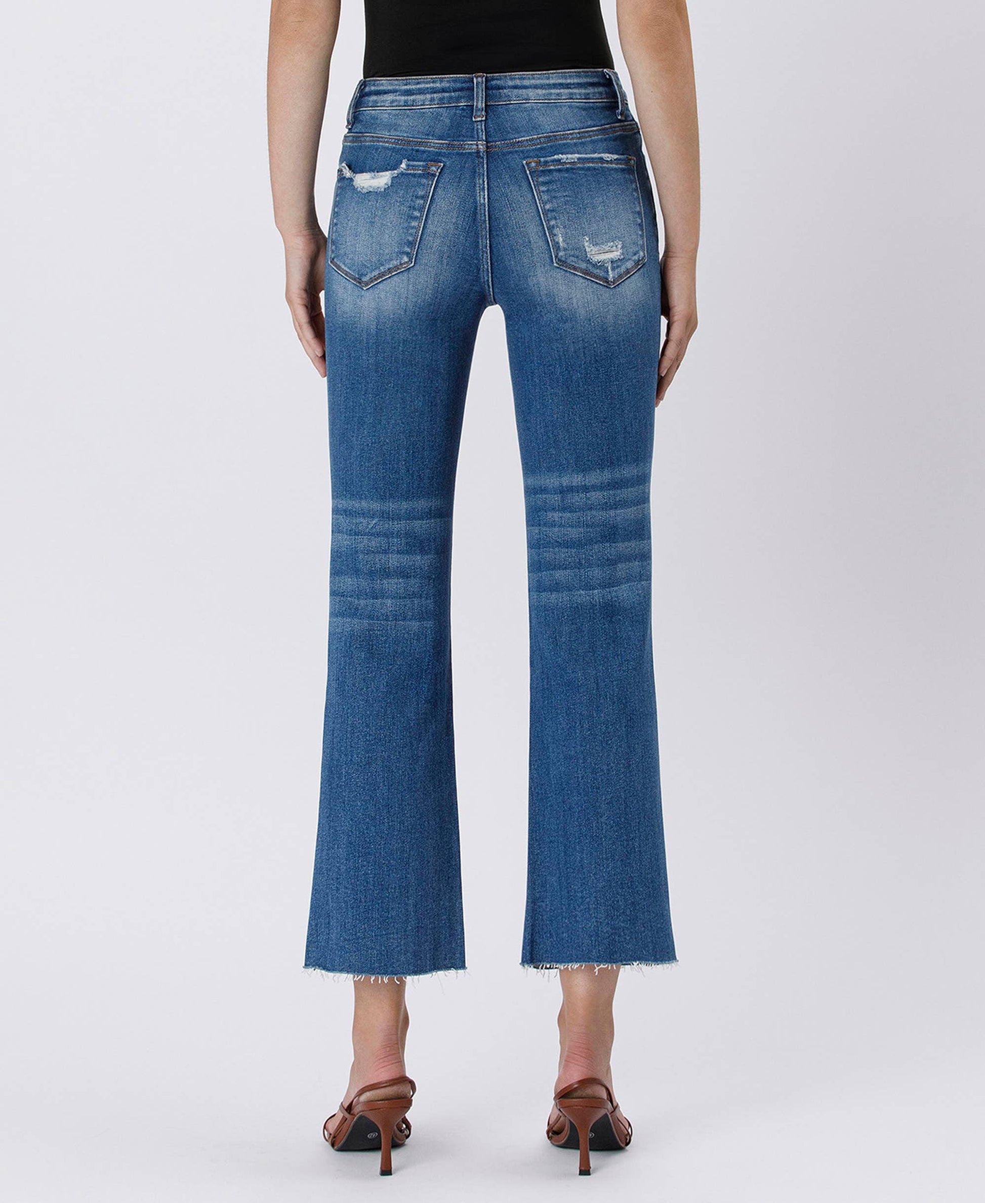 Blue jeans worn by a person on a white background