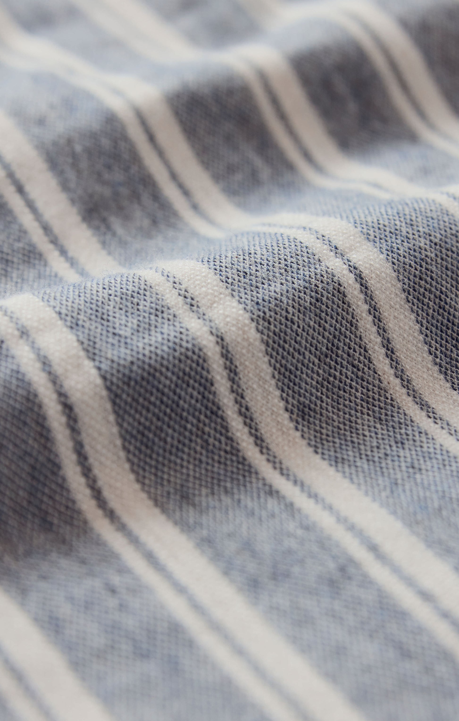 Close-up of fabric with blue and white striped pattern