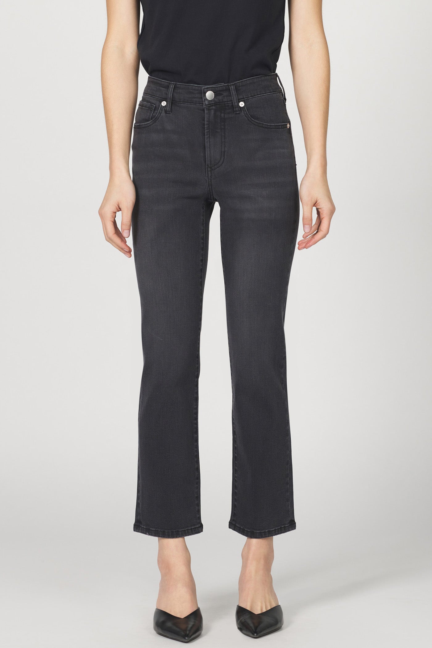 Person wearing black jeans on a white background